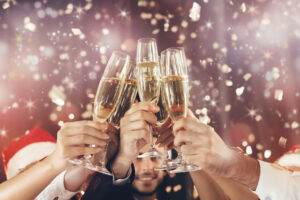 Cheers. People holding champagne glasses.